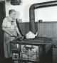 Woman cooks wood stove